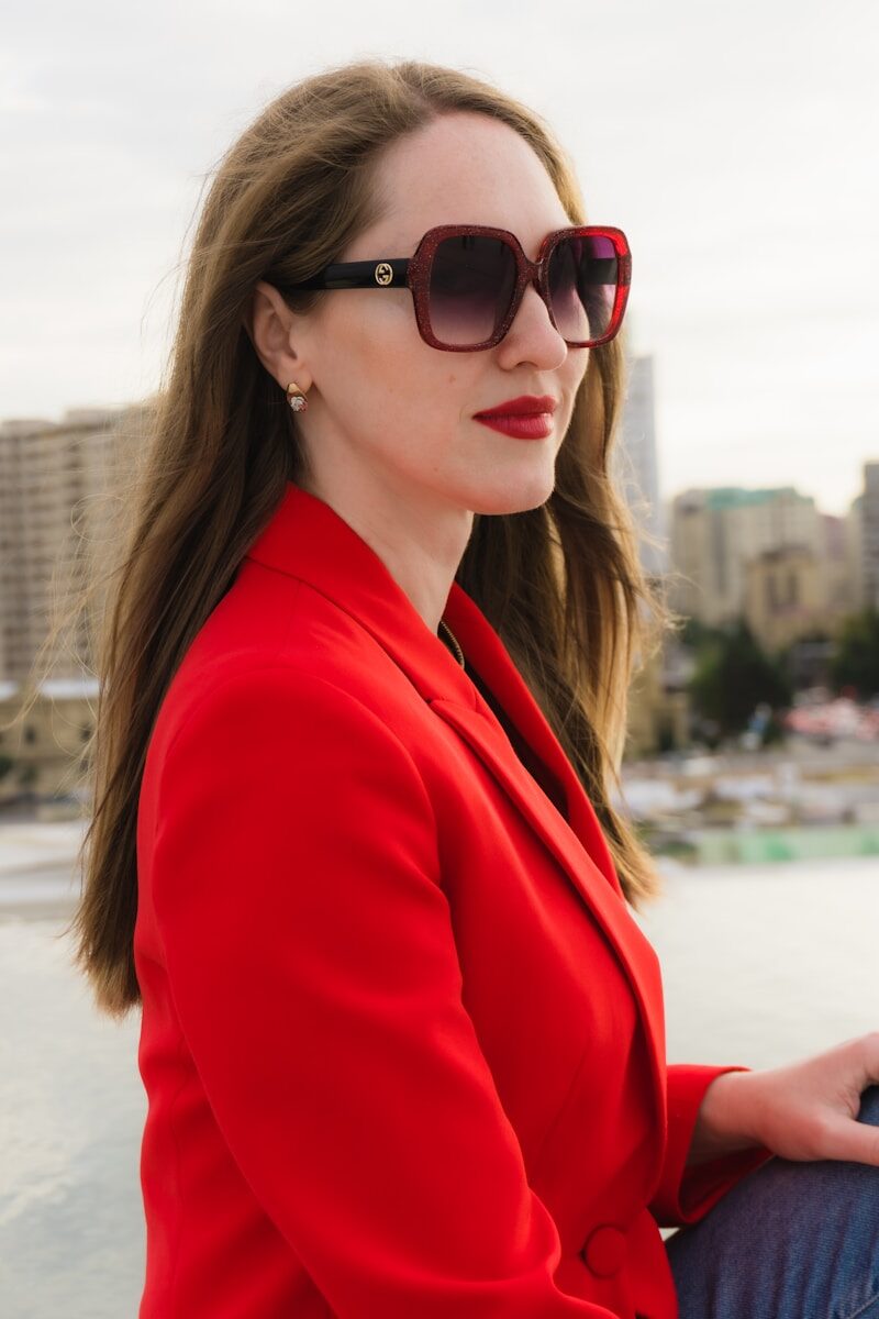 Woman in red blazer and sunglasses